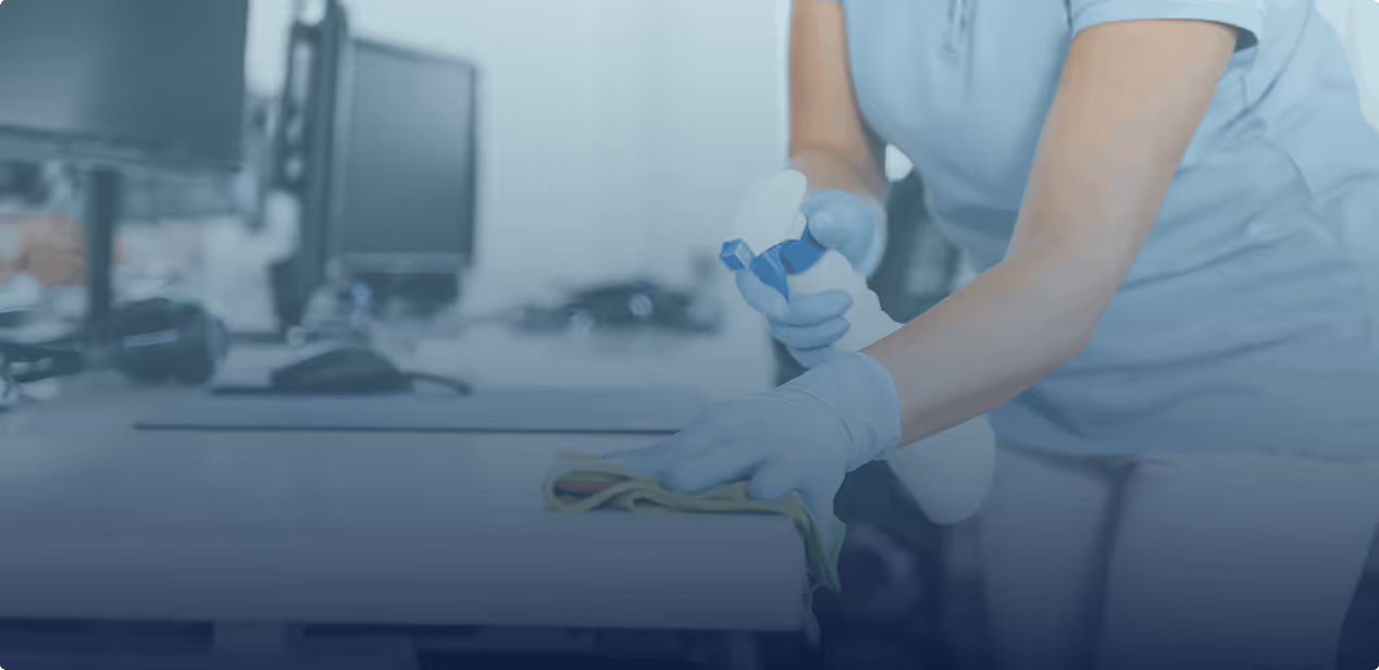 Professional office cleaning technician sanitizing workstation - EMERIH Cleaning Services Bergen County NJ